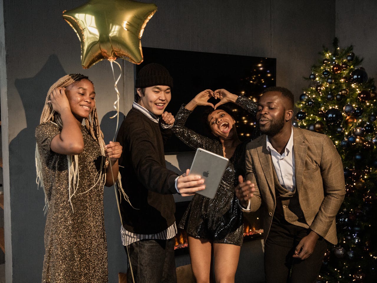 Group of friends celebrating Christmas with a festive video call indoors.
